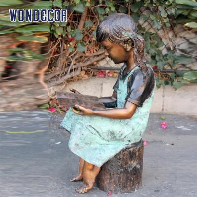 China Custom Life Size A bronze statue of a girl reading on a tree stump for sale