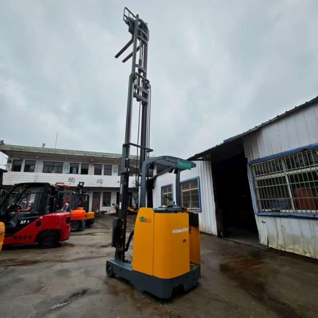 Front view of used Komatsu electric reach stacker showing controls and mast