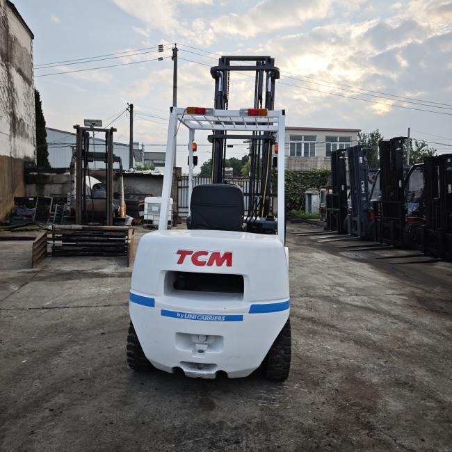 Used TCM FD30 3-ton diesel forklift front view showing mast and controls