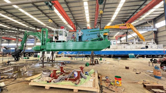 Amphibious excavator dredger machine in operation