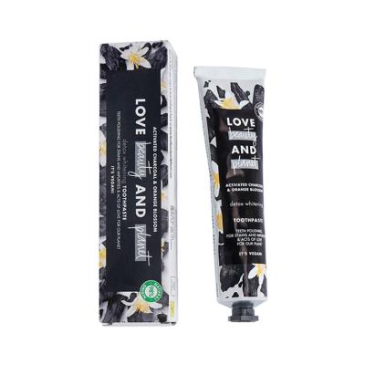 China Non Toxic Orange Blossom Activated Charcoal Toothpaste 100g For Teeth Whitening for sale