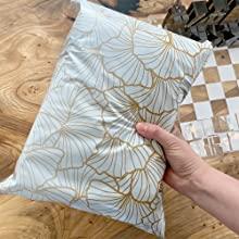 Hand holding ginkgo leaf poly mailer