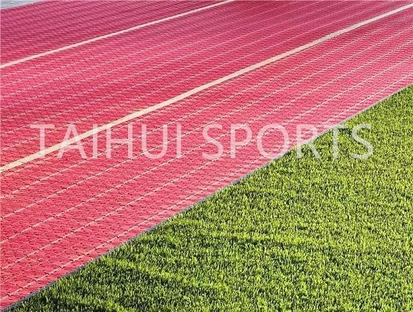 Professional installation of shock pad on sports field