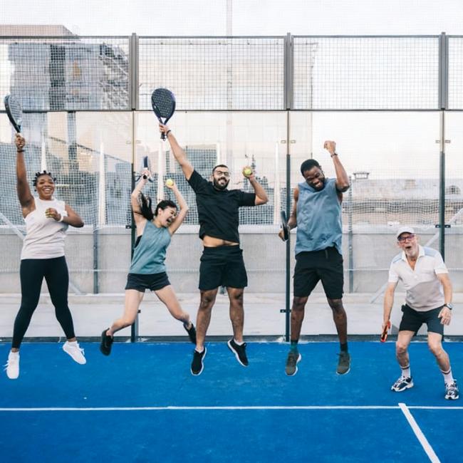 Professional padel tennis court installation showing complete court structure with glass walls and artificial turf