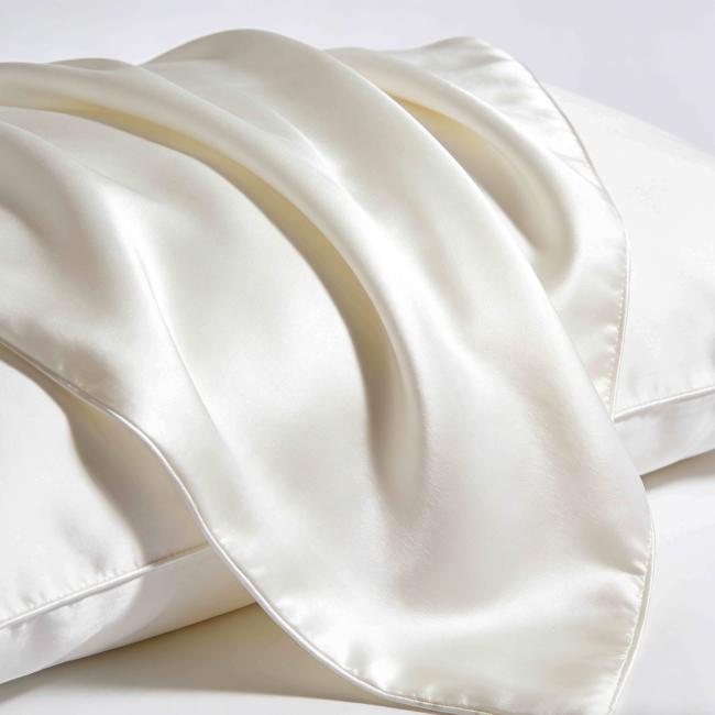 Close-up view of silk pillowcase fabric and hidden zipper detail