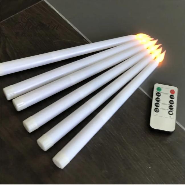 LED taper candle in clear plastic with glowing LED flame effect