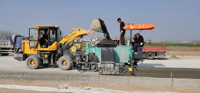 Close-up view of the SMC-523 curb slipform paver mold and auger feeding system