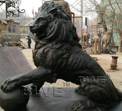China Large Black Bronze Lion Statue Metal Animal Garden Decoration With Ball for sale