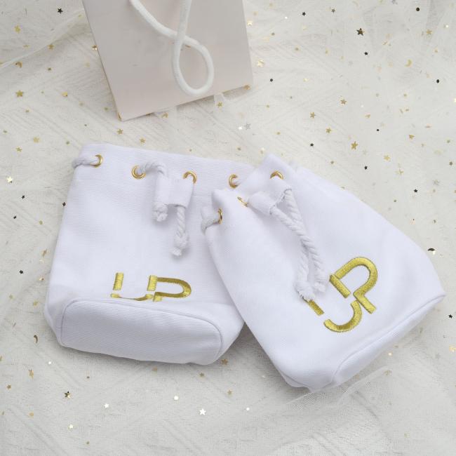 Close-up view of custom embroidery and construction details on cosmetic brush canvas pouch