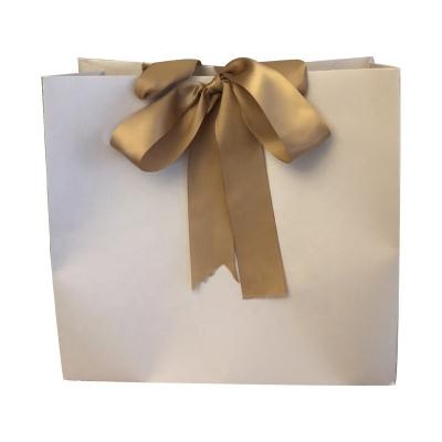 China Customized Color 100g Craft Shopping Paper Bag With Ribbon Handle for sale