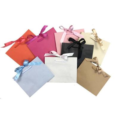 China Rope Handle Ribbon Tie Printed Paper Shopping Bag For Boutique Shop for sale