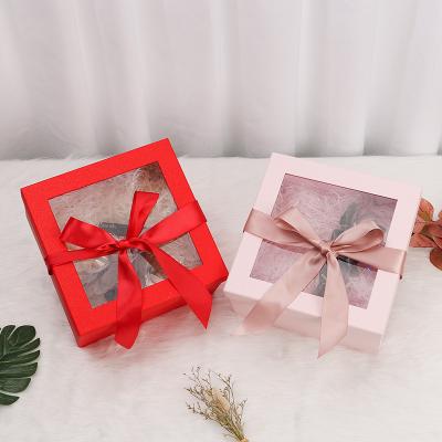 China Red Art Paper Kraft Gift Box With Window Rope Handle For Perfume Packaging for sale