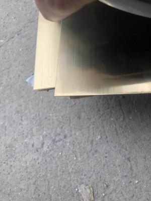 China Superficie cortada a la medida inoxidable de la rayita de la hoja de acero del oro de Champán con la película 304 Inox del PVC en venta