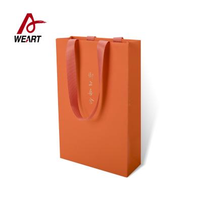 China Orange Color Fancy Paper Material Custom Printed Reusable Shopping Bags for sale