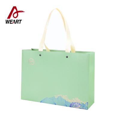 China Clothing Apparel Printed Reusable Shopping Bags , Modern Designer Paper Bags for sale