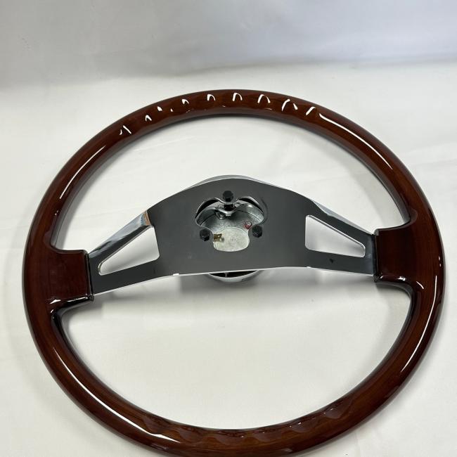 Close-up of truck wood steering wheel showing detailed wood grain and chrome finish