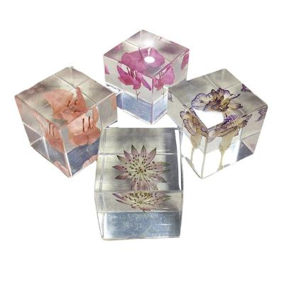 China transparent cubic shaped resin paper weight with real dry flowers for home and office decor for sale