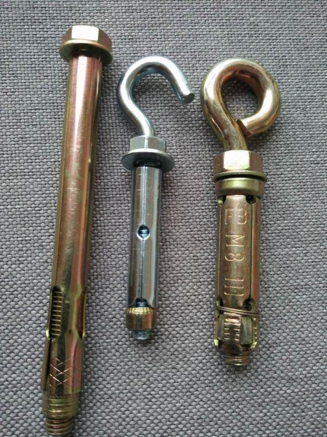 Close-up view of yellow zinc coated sleeve anchor bolt showing threading and construction details
