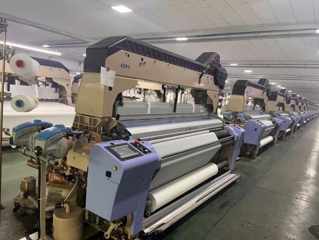 Quality control inspection of fabric rolls in production facility