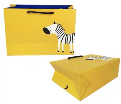China FSC ISO9001 Yellow Clothing Paper Bags Zebra Print Duplex Board Paper Bag for sale