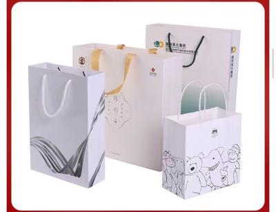China 128gsm-350gsm Art Paper Shopping Bag Simple Strokes Printing Brown Paper Grocery Bags for sale