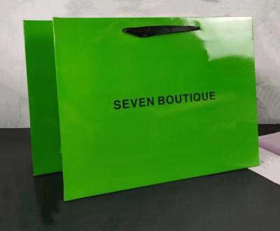 China Gold Logo 26x9x33cm Avocado Green Apparel Paper Bag With Ribbon Handle for sale