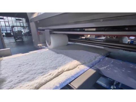 An industrial cross roller unit widening and calibrating the continuous dough band thickness evenly across the belt.