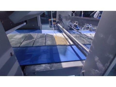 Divided square raw ciabatta dough pieces moving on the conveyor belt right after the mechanical guillotine cutting process.