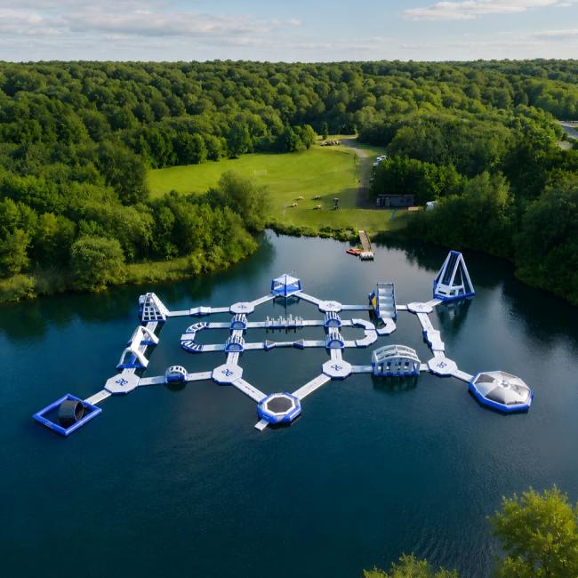 Inflatable Water Park With Floating Obstacles Slides And Climbing Areas