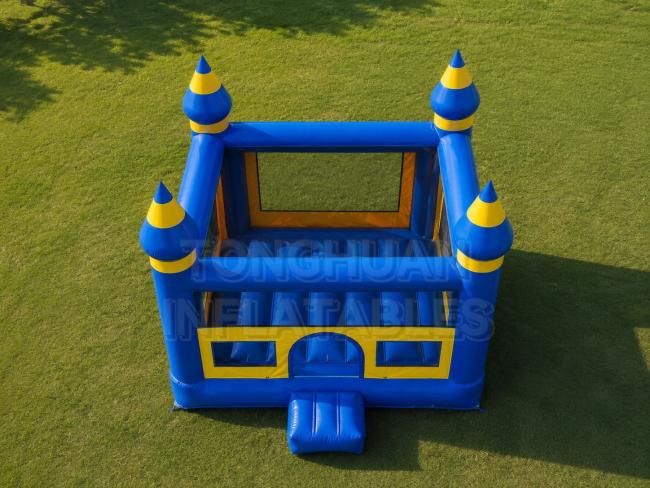 inflatable bounce house with mesh walls front entrance and bright castle theme structure