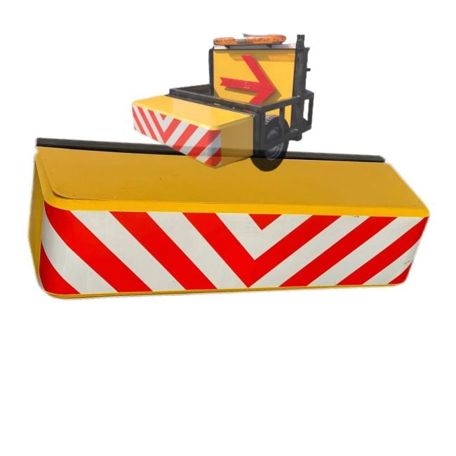 Portable highway impact attenuator showing wheeled design and warning features