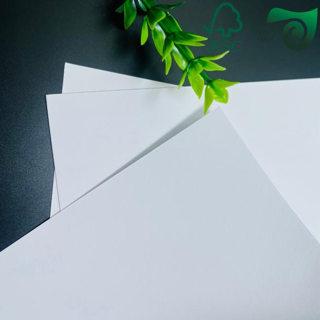 Paperboard sheets stacked showing thickness and white color