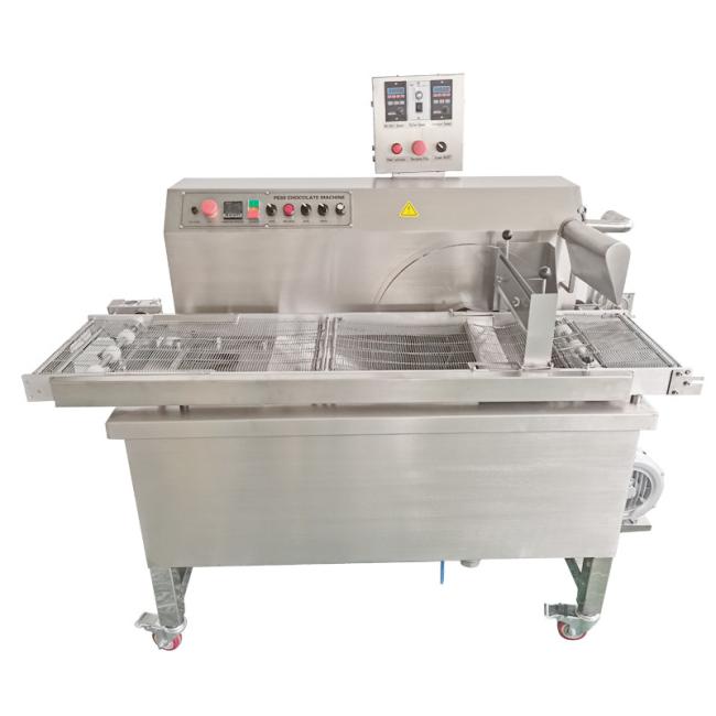 Chocolate enrober machine coating Christmas cakes