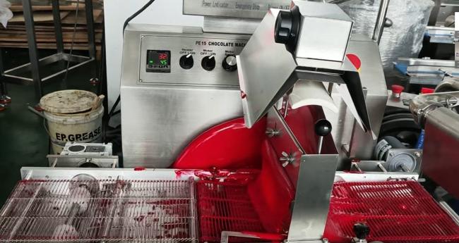 Close-up of chocolate enrobing process