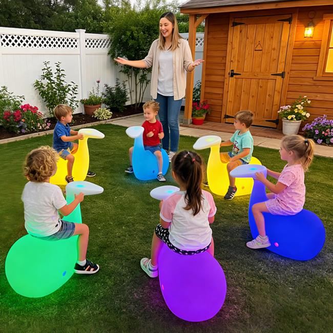 Small LED whale stool glowing in a toddler's dark room as a night light