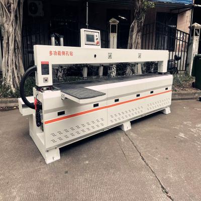 China Fully automatic woodworking three-axis linkage side hole machine CNC laser infrared side hole machine Solid wood furnitu à venda