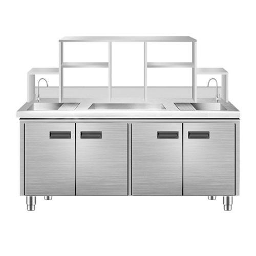 Stainless steel cabinet with double sink and storage shelves.