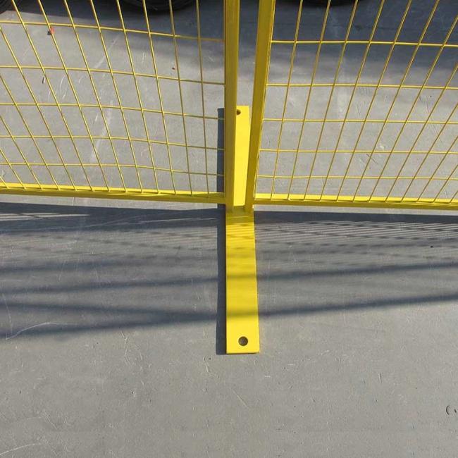 Close-up view of galvanized temporary fence construction and mesh detail