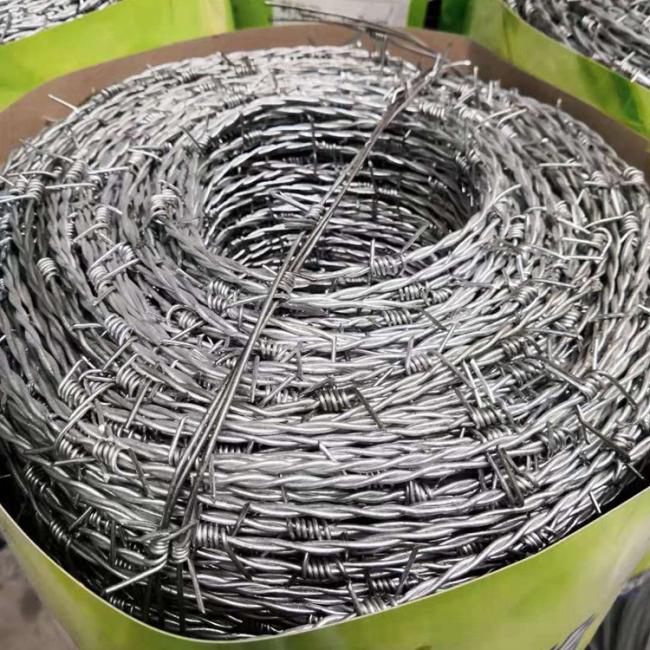 Barbed wire installation example showing security fencing application in industrial setting