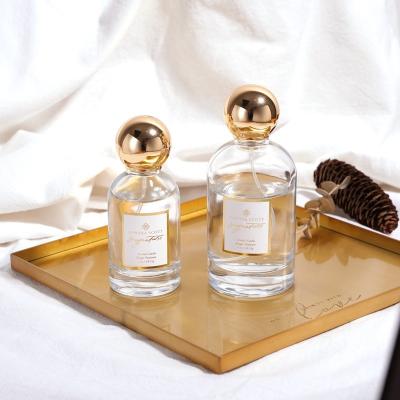 China Botella de perfume de lujo del vidrio del OEM del oro redondo vacío de Zamac 50ML 100ML en venta
