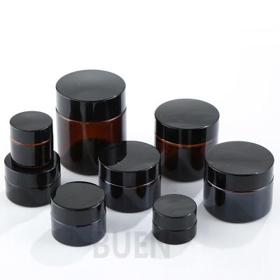 China Cylinder Amber Face Cream Glass Cosmetic Jars With Black Lid ISO90001 for sale