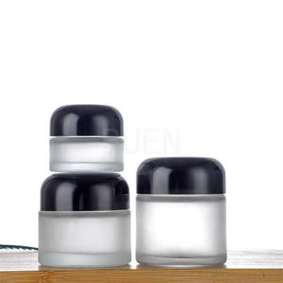 China Forsted Glass Empty Cosmetic Jars Round, Shinny Black Cap Travel Cosmetic Jar for sale