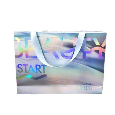 China boutique Custom Printed Paper Bags Holographic Shopping Bag With Ribbon Handle for sale