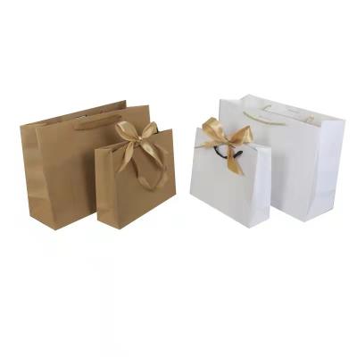 China Reusable Custom Printed Paper Bags white Kraft Paper Gift Bags for sale
