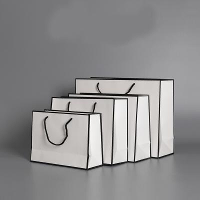 China Custom Luxury Clothing Retail Plain Gift Packing Paper Bags Black White Brown for sale