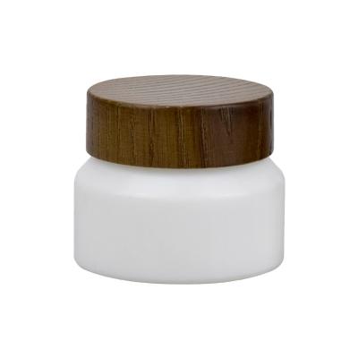 China Natural 1oz 30ml Cosmetic Cream Glass Jar Matte White Glass Clay Mask Jar With Wooden Lid for sale
