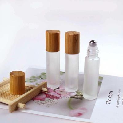China Wood Grain Bamboo Cap 3ml 5ml 10ml Frosted Roller Bottles With Stainless Roller Ball for sale