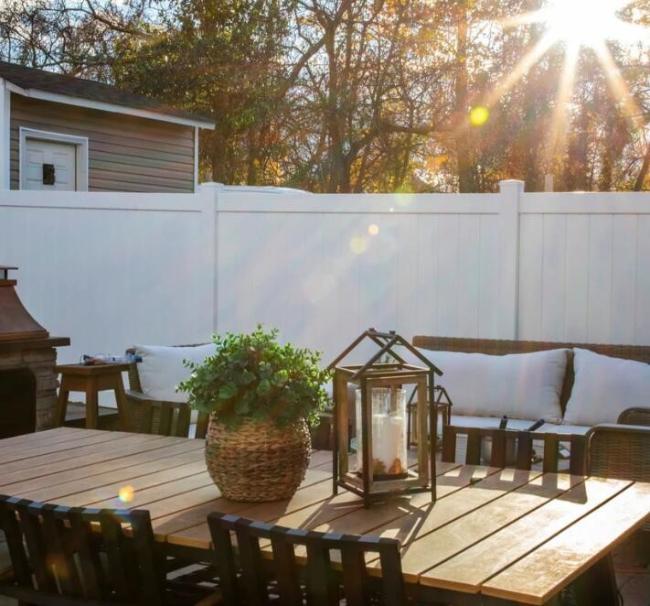 White PVC vinyl privacy fence in garden setting