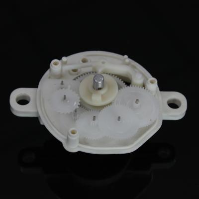 China POM Plastic Injection Moulded Plastic Auto Part Over Moulding White Motorhalter for sale