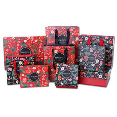 China Bolsas de papel de regalo de Navidad de tela de regalos Bolsa de papel de regalo de compras de lujo de impresión en color en venta